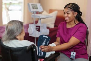 A nurse with a resident at Primrose Post-Acute